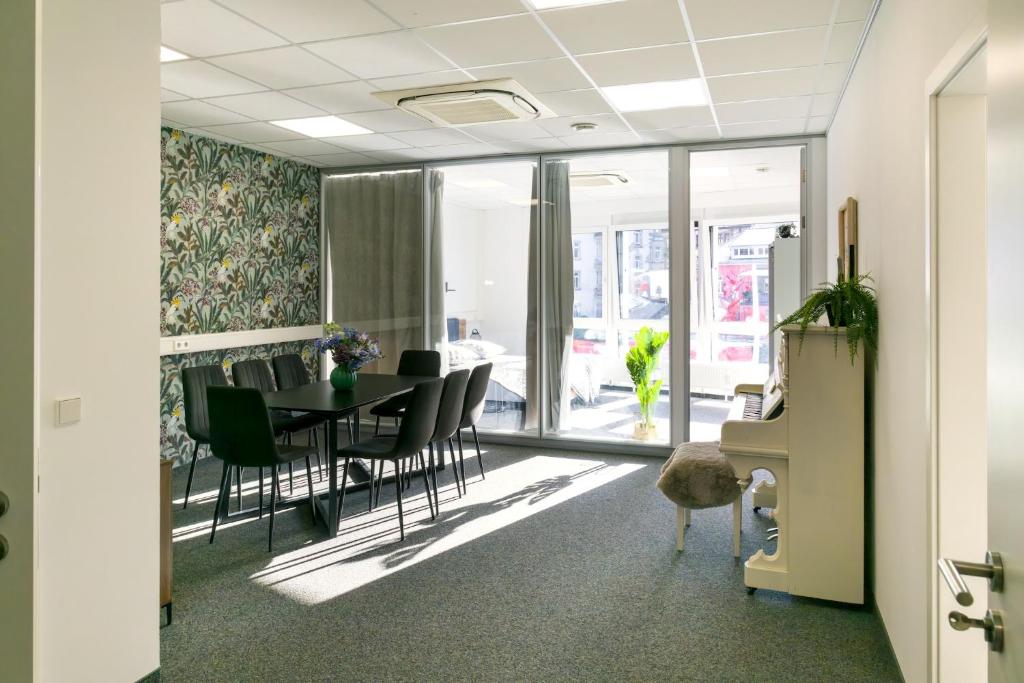 an office with a dining room with a table and chairs at Schlossberg Residence in Freiburg im Breisgau