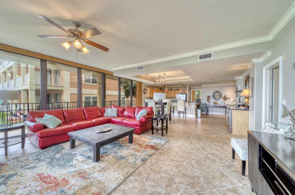 a living room with a red couch and a table at Holiday Isle 122 in Dauphin Island