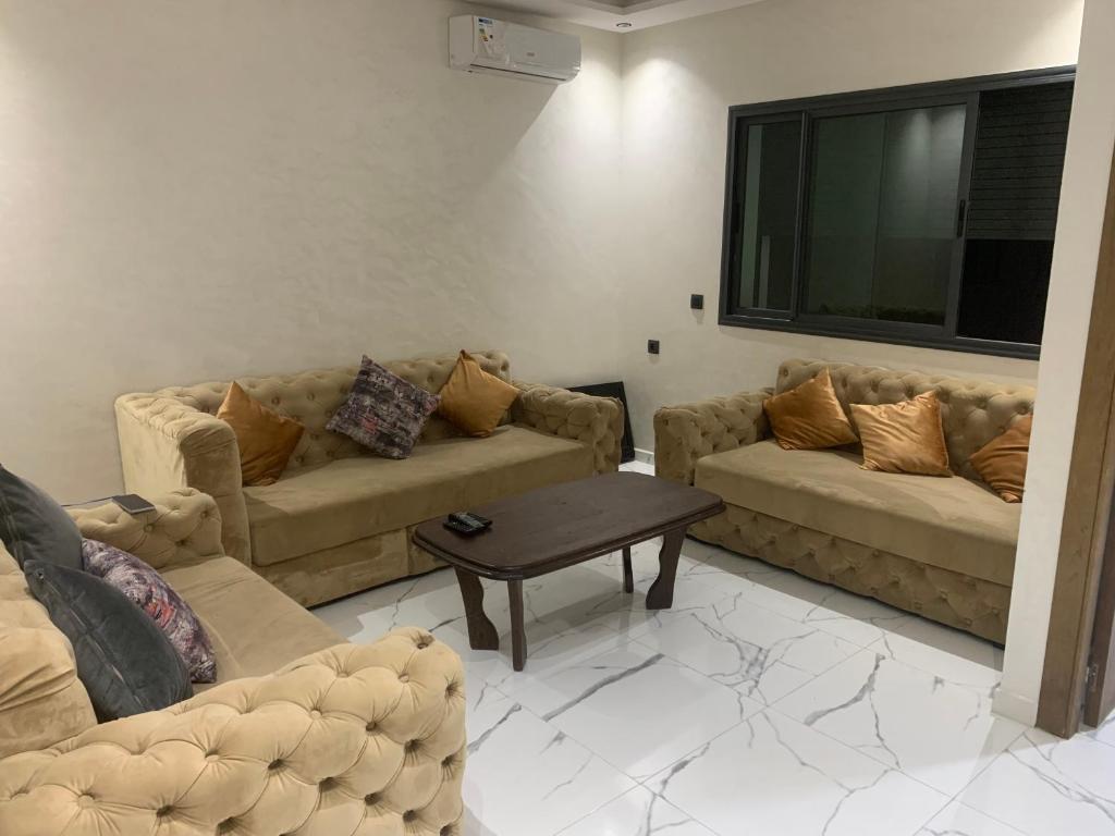a living room with two couches and a table at Studio dream place in Kenitra