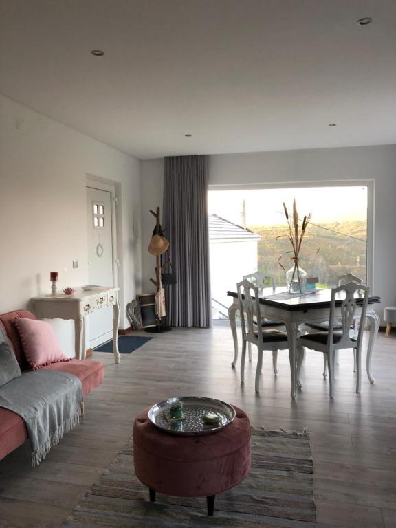 a living room with a couch and a table at Casinha da Aurora in Pedorido