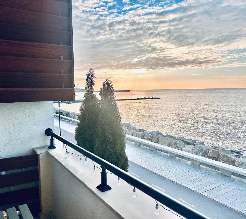 a view of the ocean from the balcony of a building at Apartment Sea Sunrise, complex Carpe Diem, FREE PARKING in Balchik