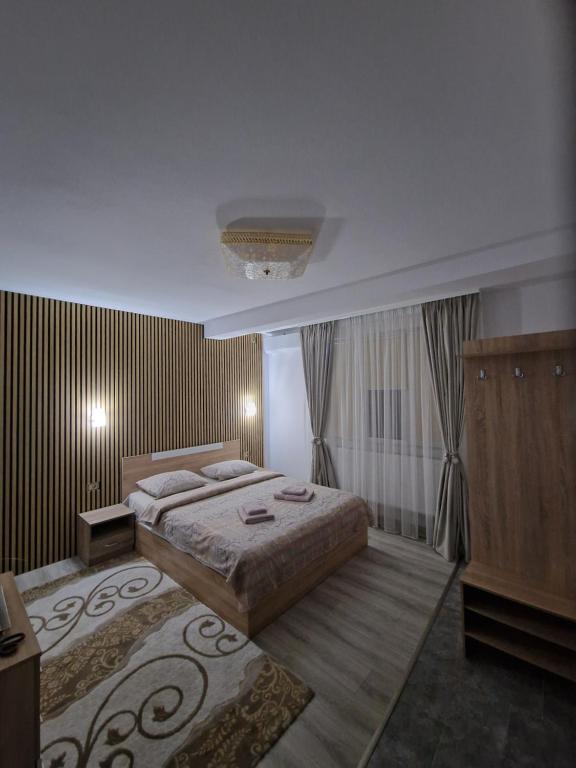 a bedroom with a large bed in a room at Casa DARYA-24h Check-in in Bucharest