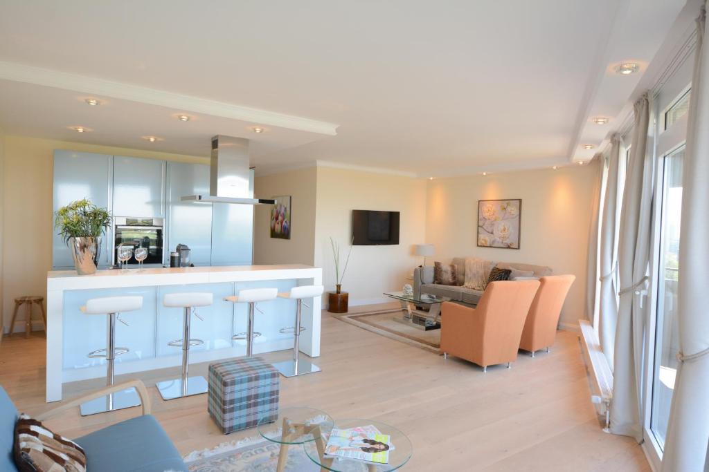 a large living room with a kitchen and a living room at Luxury apartment in Düsseldorf near trade fair in Düsseldorf