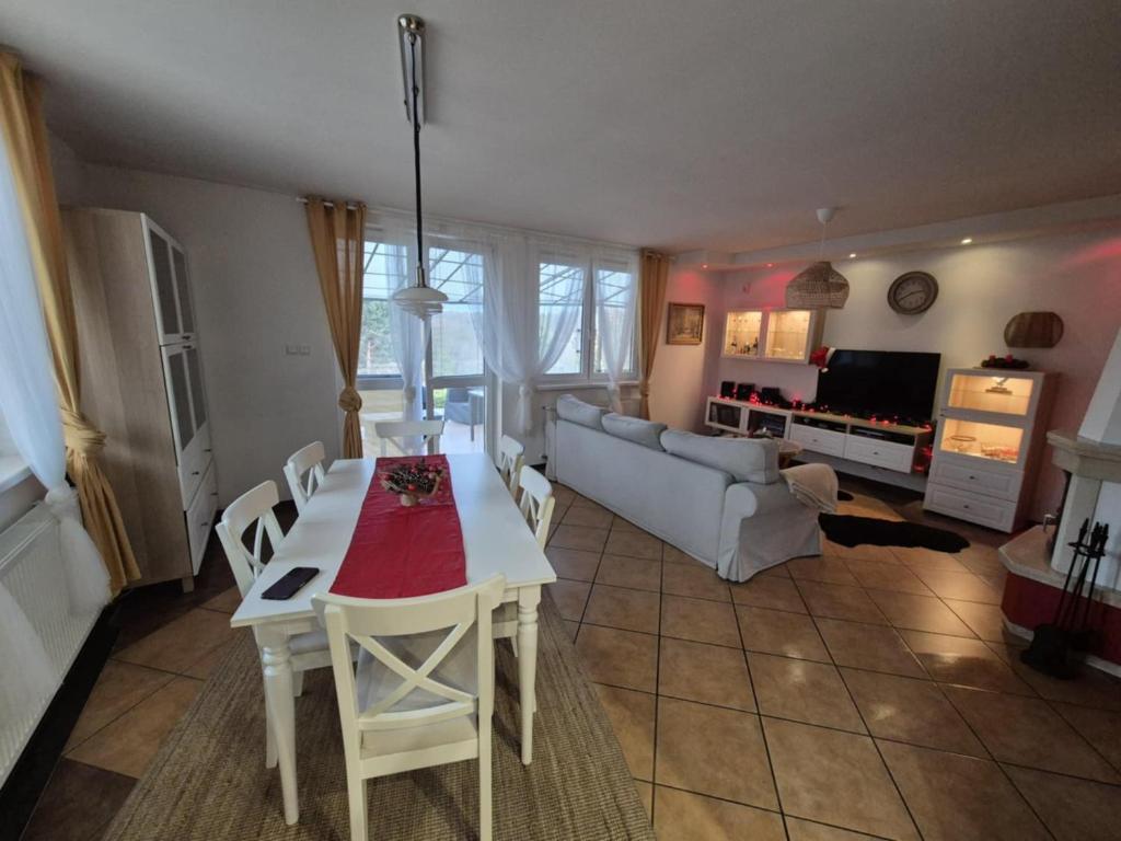 a living room with a table and a couch at Dom pod flagą in Sobącz