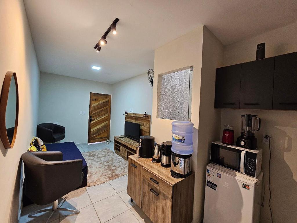 a kitchen with a refrigerator and a microwave at Maria Bonita Apartment | Cozy, 10 minutes from the city center in Caruaru