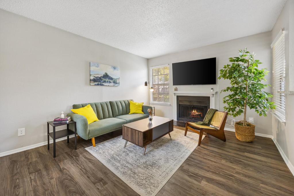 a living room with a couch and a fireplace at Emerald Loft - Pool, Gym & Free Parking! in Dallas