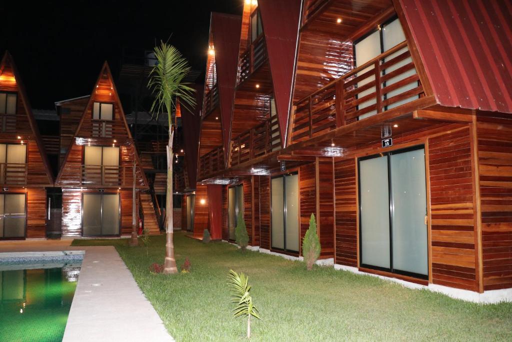 a building with a pool in front of it at Alpinas Natural Suites in Lunahuaná