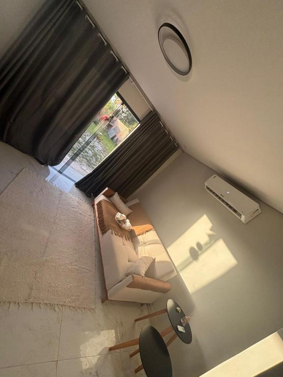 an overhead view of a living room with a chair and a window at Casa da Praia Bem Viver in Santa Cruz Cabrália