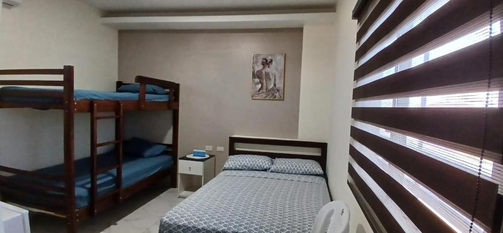 a bedroom with two bunk beds and a bed at Suites del Pacífico in Salinas