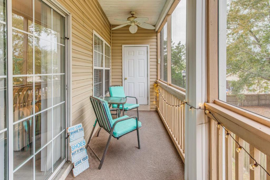 a screened porch with two chairs and a fan at Condo w/ Pool Access, 1 Mi to Cherry Grove Beach in Myrtle Beach