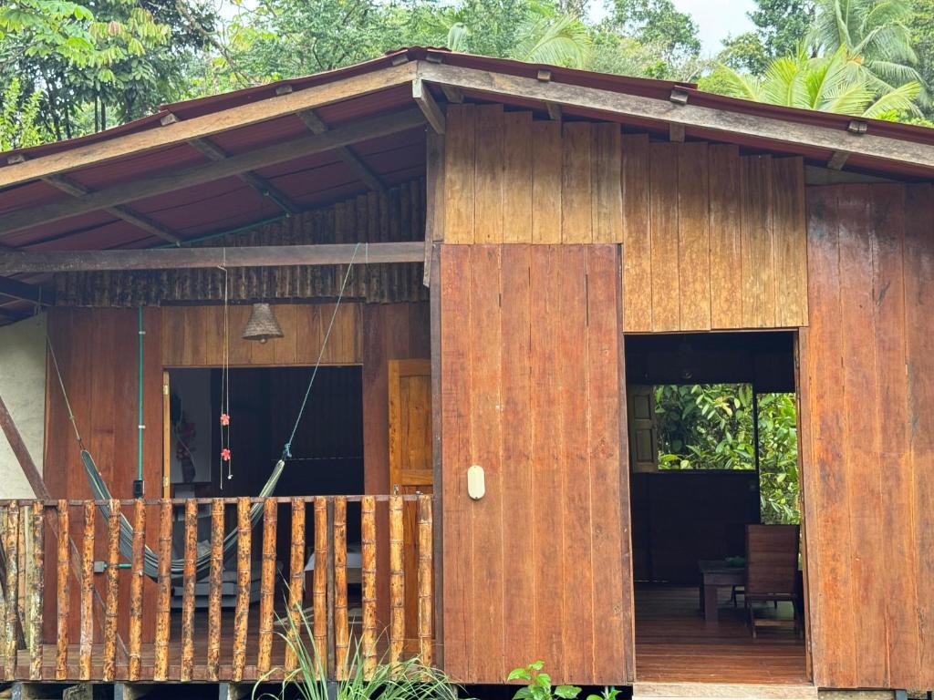 a small wooden house with a porch at Casa Selva in El Valle