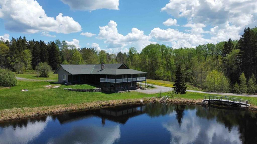 a large house on the side of a lake at Cajun Cabin Private Nature Resort in Minden