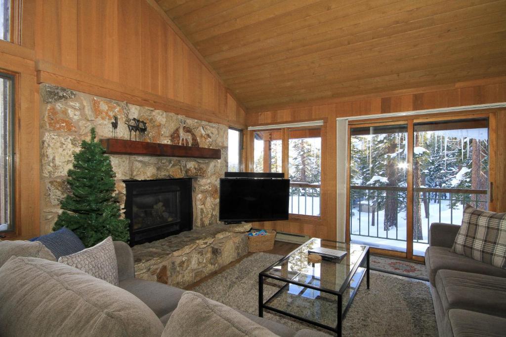 a living room with a couch and a fireplace at Mountainback 116 LoftCorner in Mammoth Lakes