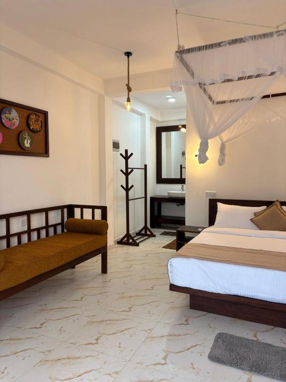 a bedroom with a bed and a mirror at Liora Cottage Ella in Ella