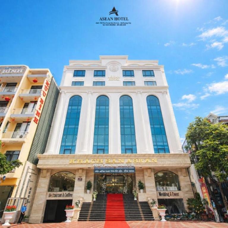 a building with a red carpet in front of it at Asean Hotel in Hải Dương