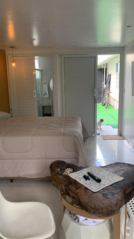 a bedroom with a large bed and a table with at Conchas Lofty in Governador Celso Ramos