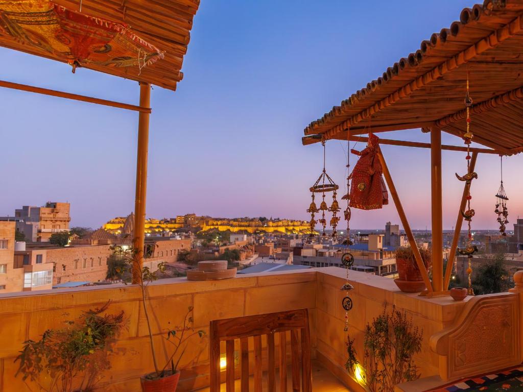 a rooftop bar with a view of a city at Hotel The Silk Route in Jaisalmer