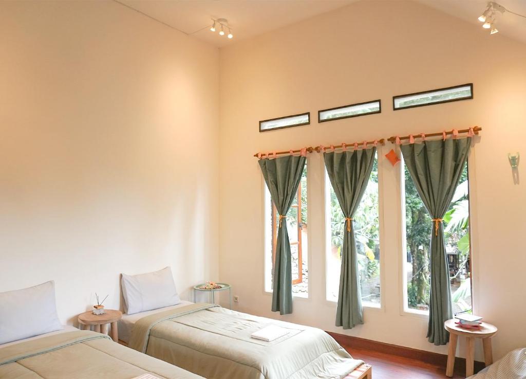 a bedroom with two beds and a window at MiTS in Bandung