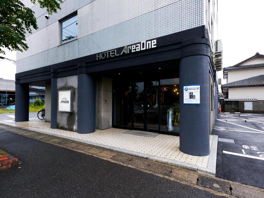 a hotel entrance with blue columns in a building at Hotel Areaone Naruto in Naruto