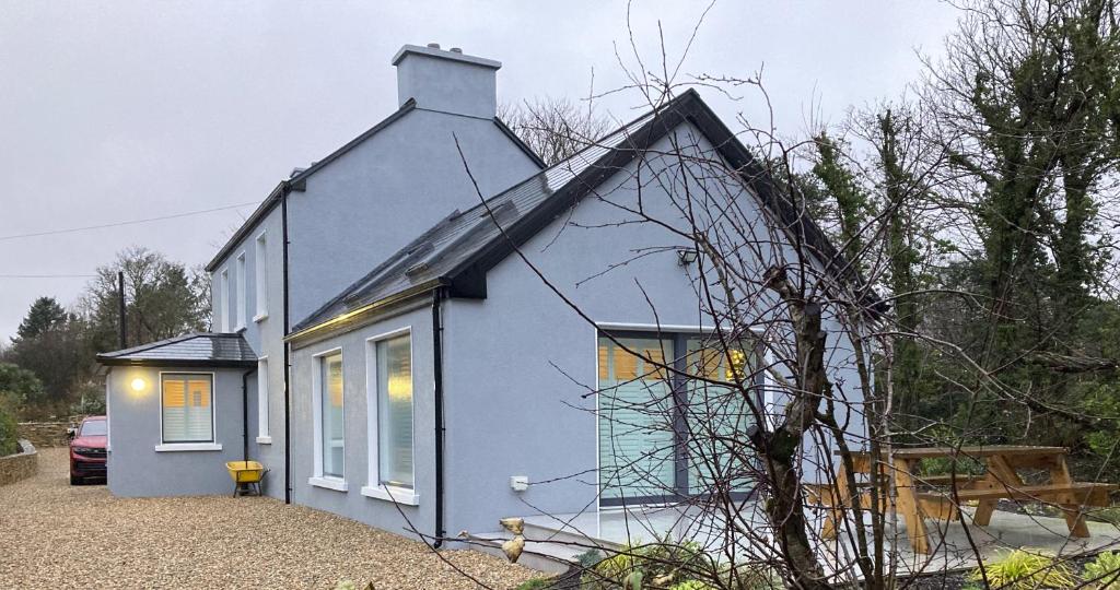 a blue house with a gambrel roof at Willow in Clifden