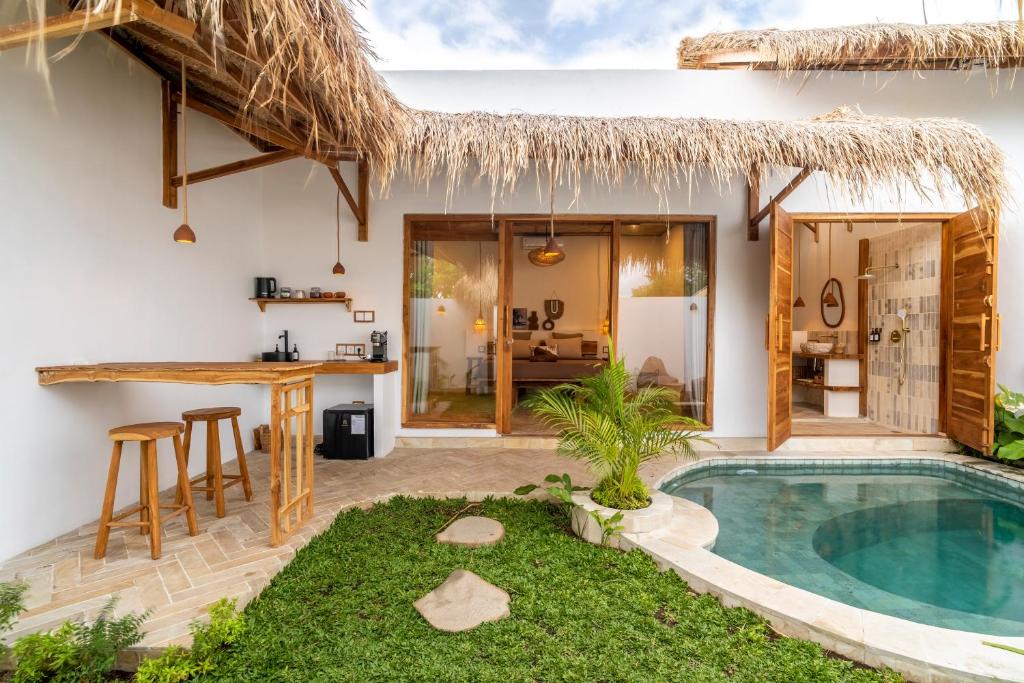 a villa with a swimming pool and a kitchen at Teman Private villa with pool in Gili Islands