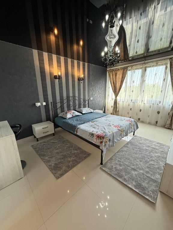 a bedroom with a bed and two rugs in it at Apartment Saturn in Galaţi