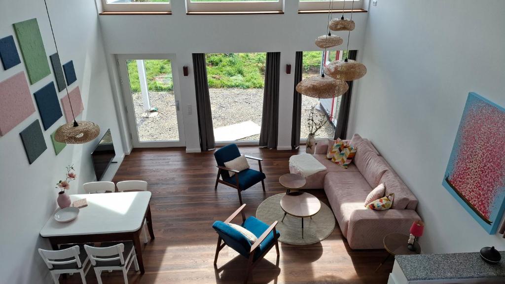 a living room with a couch and chairs at Finkennest am Desenberg in Warburg