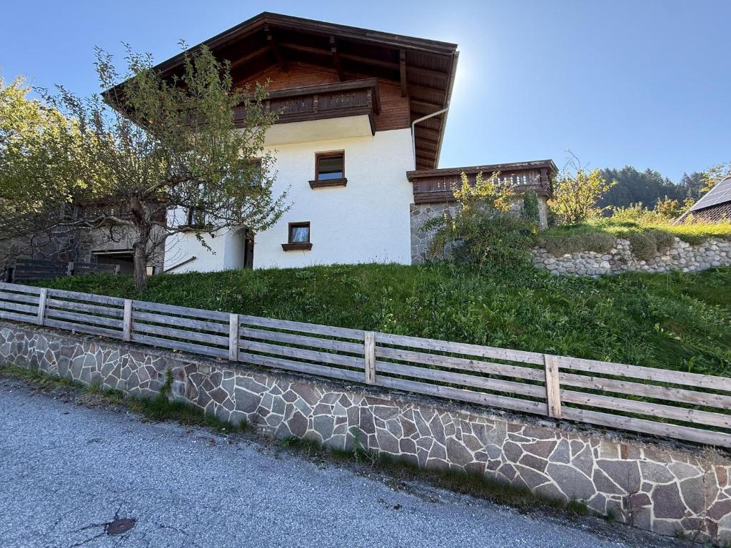a house on a hill with a fence at Holiday home with panoramic views in Tulfes