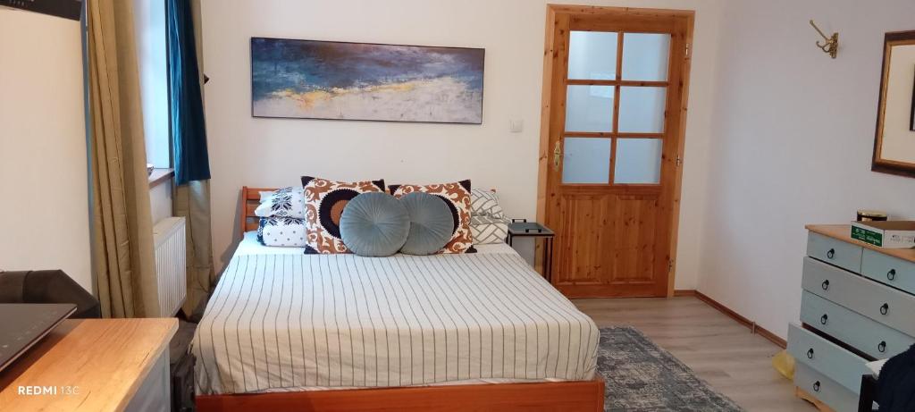 a bedroom with a bed with pillows on it at Garsonka u pivovaru, centrum Rožnov in Rožnov pod Radhoštěm