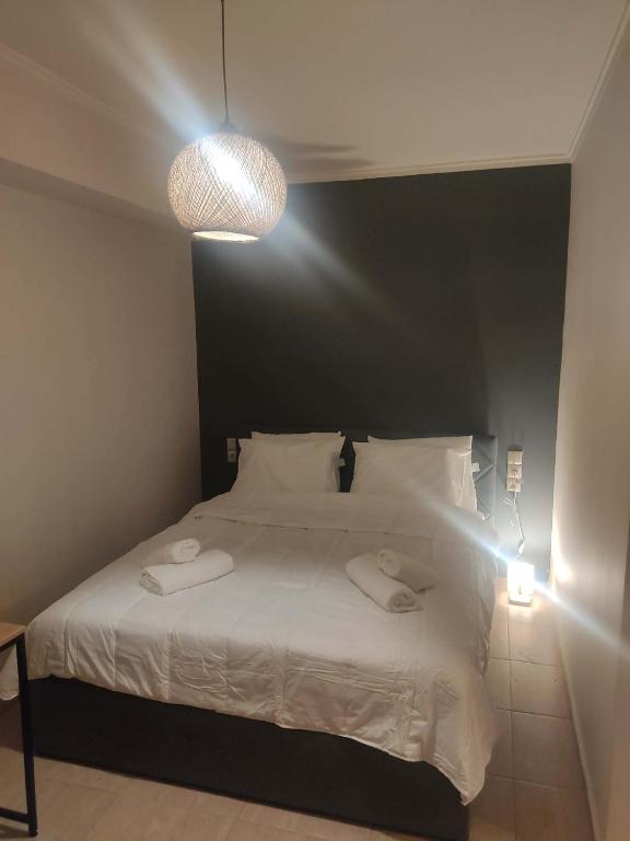a bedroom with a bed with two towels on it at Super central studio apartment in Kalavrita
