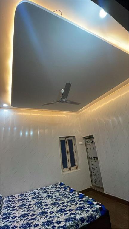 a room with a bed and a white wall at Shree residences in Vrindāvan