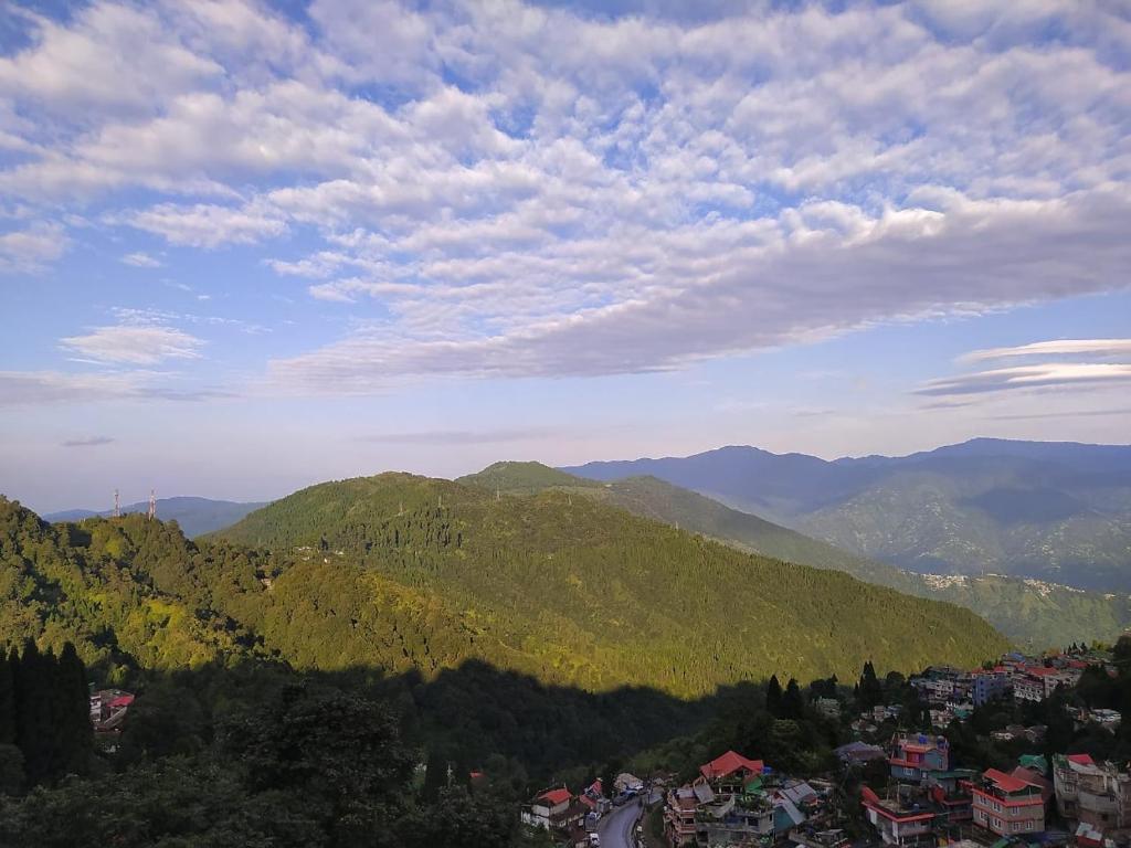 a view of a town in a mountain valley at Mandira Homestay in Jālāpahār