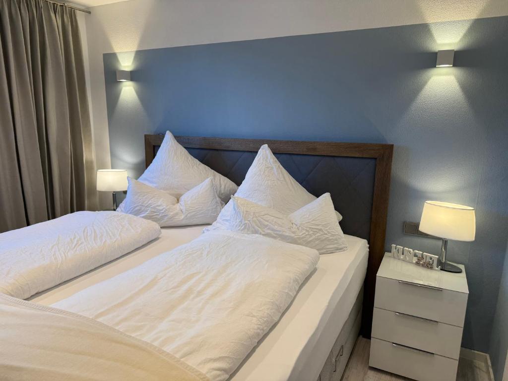 a bedroom with two beds with white sheets and pillows at Ferienwohnungen Köhnke in Hahnenklee-Bockswiese