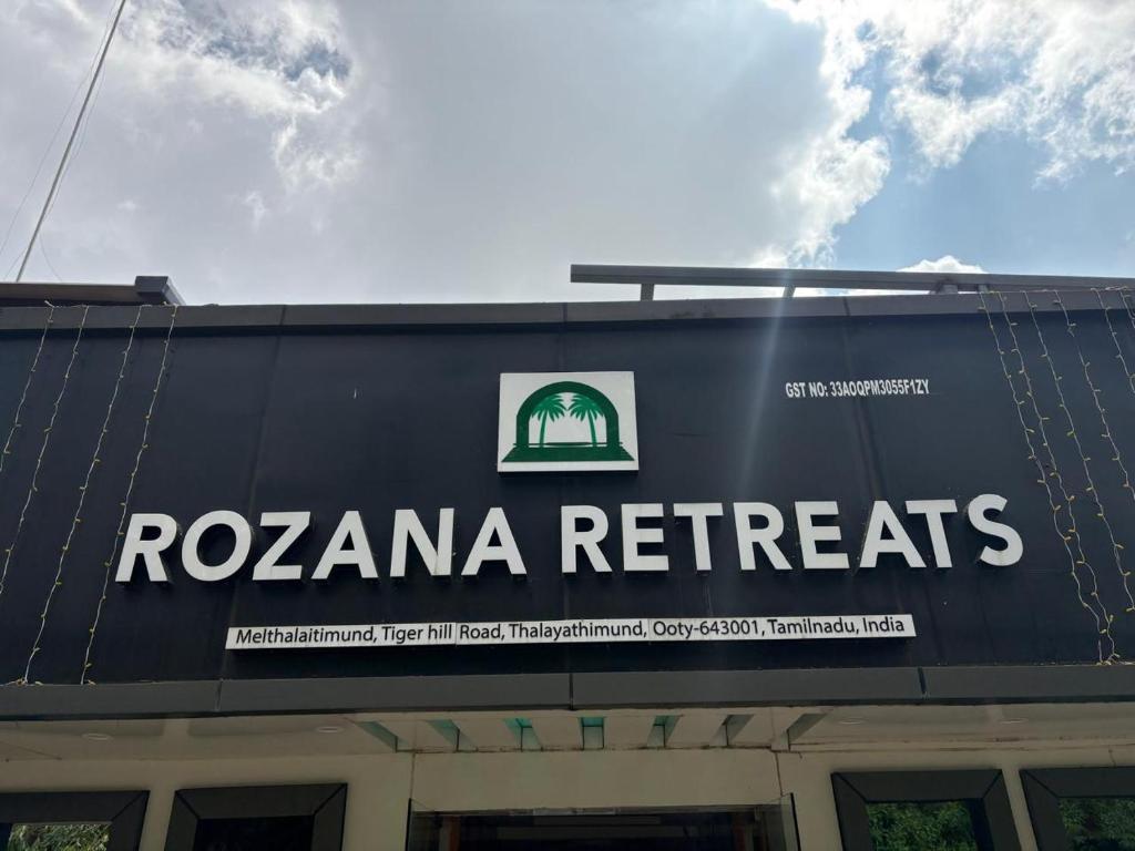 a sign on the side of a building at Rozana Retreats Ooty in Ooty
