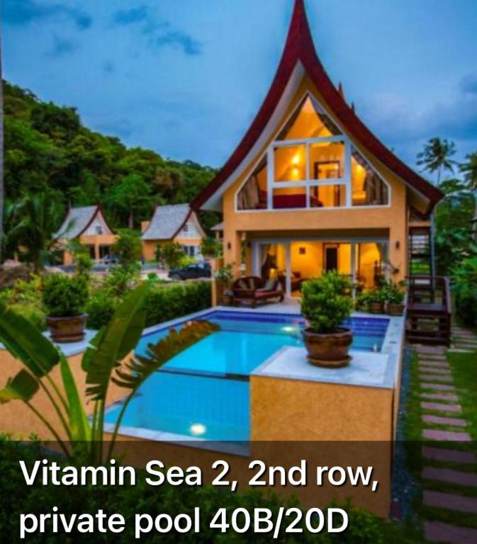 a house with a swimming pool in front of it at vitamin sea villas in Ko Chang
