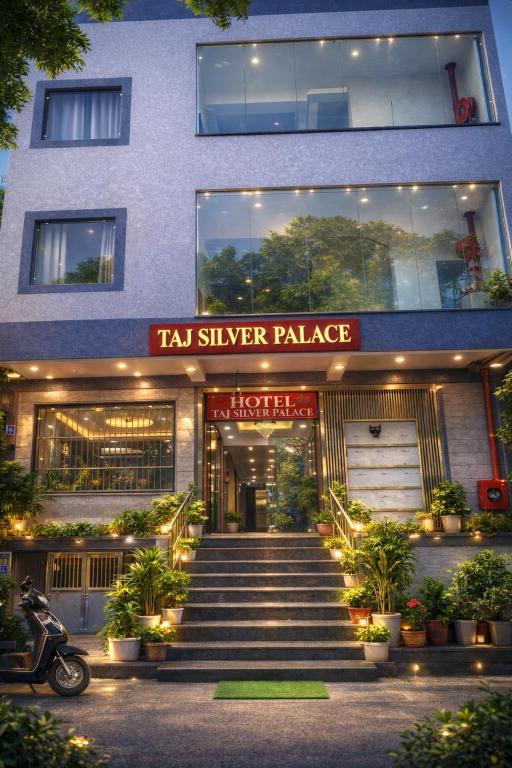 a building with a staircase leading to a taxi silver palace at Hotel Taj Silver Palace in Agra