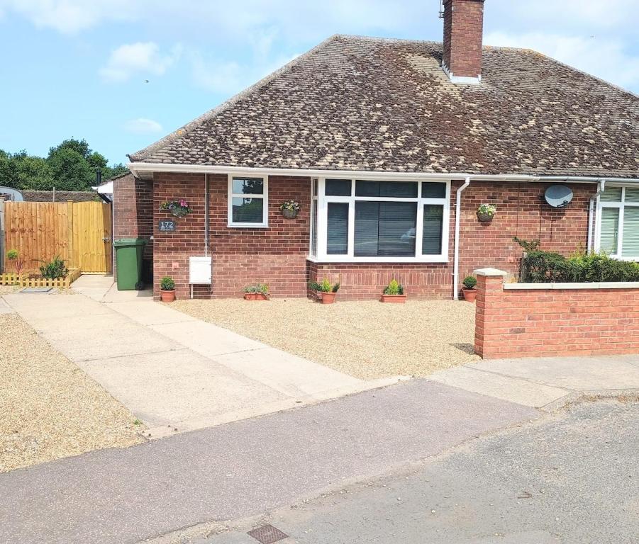 a red brick house with a driveway at Bideawee in Belton