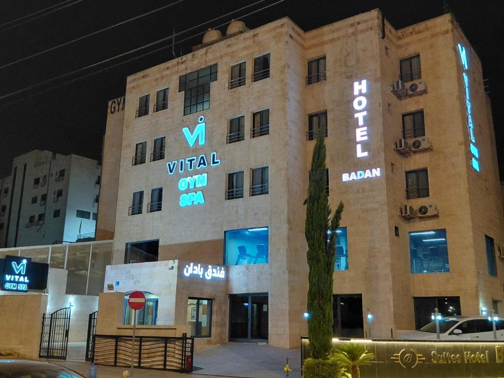 a building with a sign on the side of it at Badan Suites & Hotel in Amman