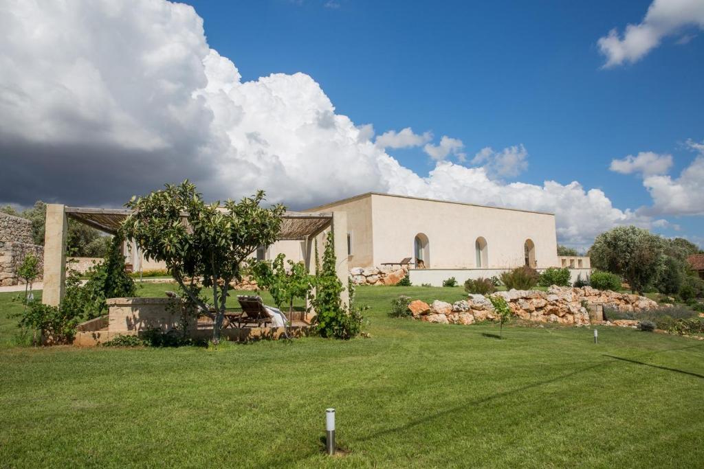 a house with a large yard in front of a building at Agriturismo Spirdo in Ruffano