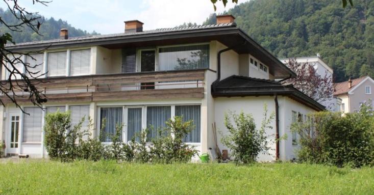 a large white house in a field of grass at Ferienhaus Fisch in Bad Ragaz
