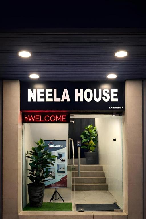 a needia house sign on the front of a building at Neela House in Labuan