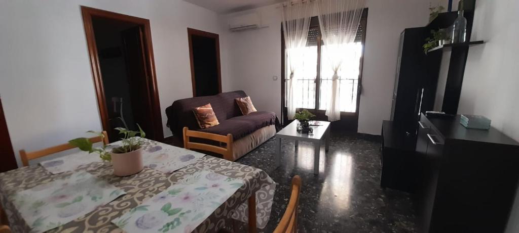 a living room with a table and a couch at Alejandra in Armilla