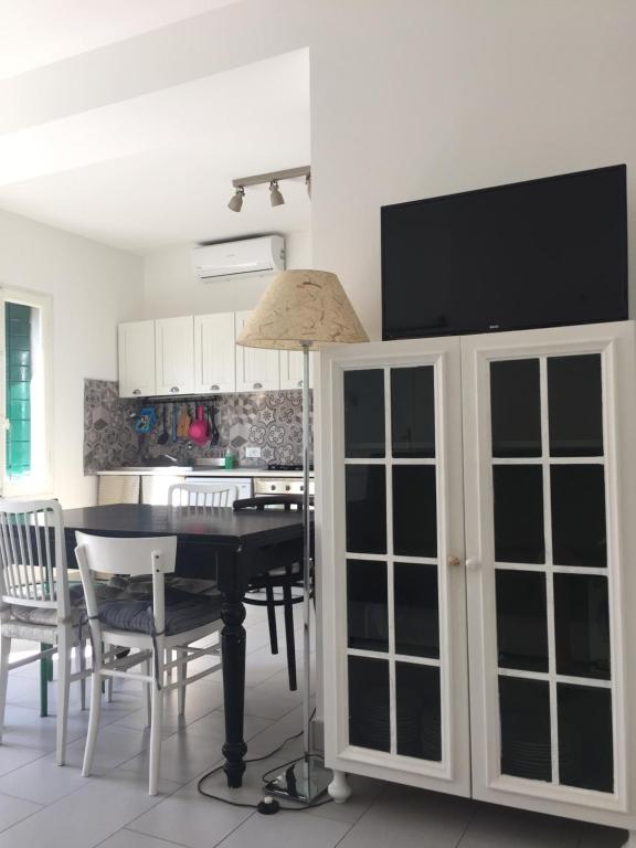a dining room with a black table and a desk at Casa Andrean PT Lido Venezia in Venice-Lido