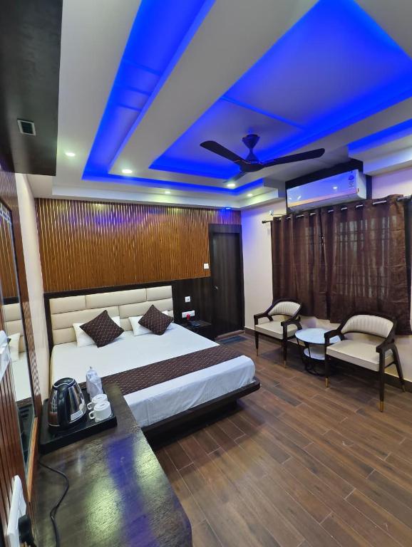 a bedroom with a bed and a blue ceiling at Mohar Residency Madhyamgram in kolkata