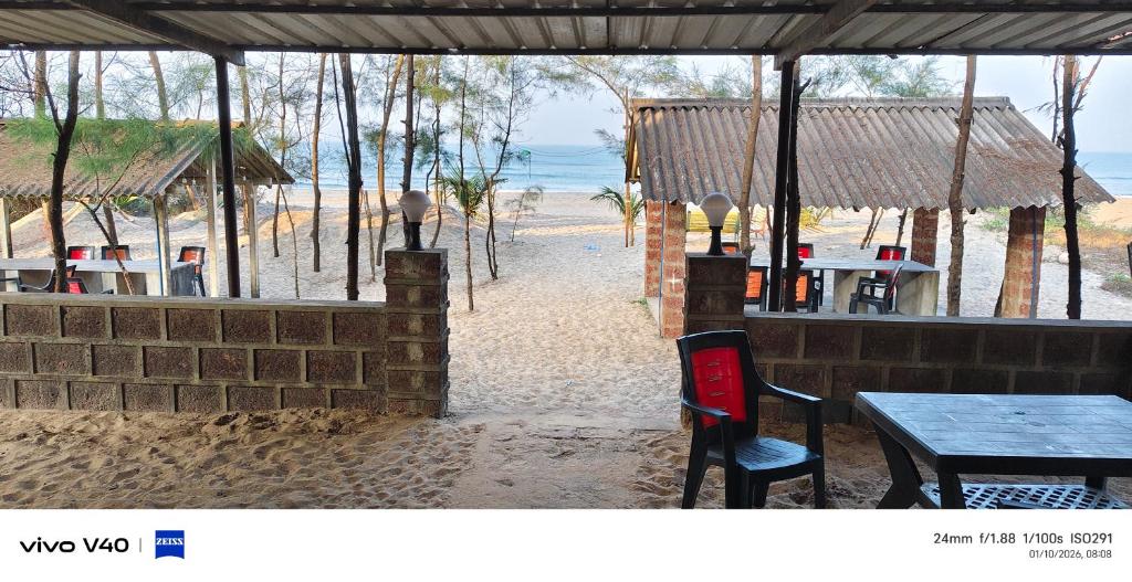 a restaurant with a table and chairs on the beach at Silver sand beach resort in Malvan