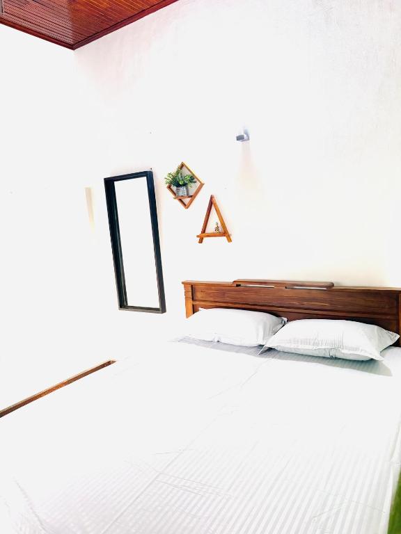 a bedroom with two beds and a mirror at S70 Villa in Dickwella