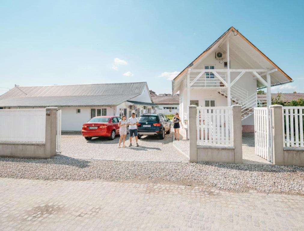a group of people standing outside of a house at Pixel Guesthouse in Târgu Secuiesc