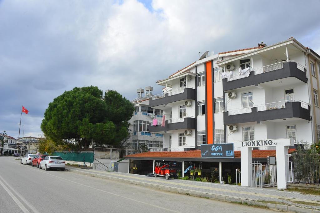 a large white building on the side of a street at Side Lion king aprt in Side