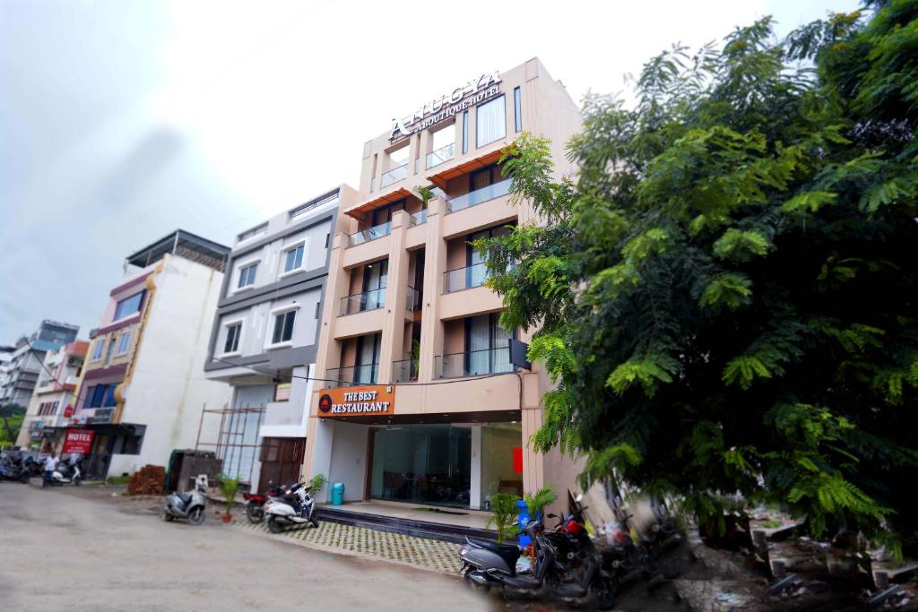 a building with motorcycles parked in front of it at Hotel Anugya in Indore