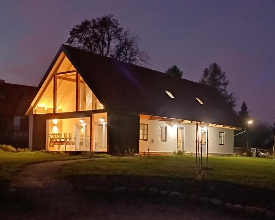 a large white house with a black roof at night at Chalupa Louka in Slavonice